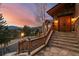 Inviting front entrance with stone steps leading to double wooden doors and a picturesque view at 127 Granite Way, Evergreen, CO 80439