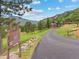 Secluded mountain home on expansive lot, framed by lush greenery and mature trees at 127 Granite Way, Evergreen, CO 80439