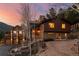 Exterior view of home at sunset with stone facade at 127 Granite Way, Evergreen, CO 80439