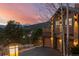 Well-lit home exterior at dusk with stone accents and an attached two-car garage at 127 Granite Way, Evergreen, CO 80439
