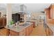 Spacious kitchen with stainless steel appliances, granite counters, and a large island with a gas cooktop at 127 Granite Way, Evergreen, CO 80439