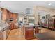 Well-appointed kitchen featuring granite countertops, an island with a cooktop, custom cabinets, and stainless steel appliances at 127 Granite Way, Evergreen, CO 80439