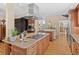 Open kitchen featuring granite countertops, an island cooktop, custom cabinets, and hardwood floors for a warm ambiance at 127 Granite Way, Evergreen, CO 80439