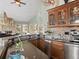 Well appointed kitchen with custom wood cabinetry and views into the living room at 127 Granite Way, Evergreen, CO 80439