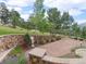 A landscaped yard featuring rock walls, gravel paths, and trees, offering a serene outdoor space at 127 Granite Way, Evergreen, CO 80439