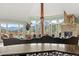 Spacious living room with vaulted ceilings, stone fireplace, large windows showcasing mountain views and unique decor at 127 Granite Way, Evergreen, CO 80439