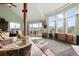 Bright living room featuring vaulted ceilings, view of mountains and deck, and decorative item at 127 Granite Way, Evergreen, CO 80439