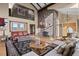 Elegant living room featuring a stone fireplace, high ceilings, and comfortable seating at 127 Granite Way, Evergreen, CO 80439