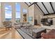 Bright living room with soaring ceilings, large windows, and stylish furnishings at 127 Granite Way, Evergreen, CO 80439