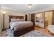 Spacious main bedroom featuring an elegant bed frame, a patterned rug, and a luxurious bathroom at 127 Granite Way, Evergreen, CO 80439