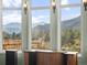 Breathtaking mountain views from the large windows in this home with a mountain side deck at 127 Granite Way, Evergreen, CO 80439