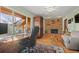 Sunlit office with large windows and a brick fireplace is ideal for remote work at 127 Granite Way, Evergreen, CO 80439