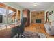 Office space featuring a large window with a view and brick fireplace at 127 Granite Way, Evergreen, CO 80439