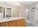 Bright bathroom featuring double sinks and a shower-tub combo at 10650 Ashfield St, Highlands Ranch, CO 80126