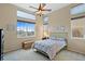 Inviting bedroom with abundant natural light, neutral walls, ceiling fan, and plush carpeting at 10650 Ashfield St, Highlands Ranch, CO 80126