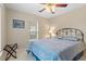 A comfy bedroom with a ceiling fan and blue paisley bedding for a touch of elegance at 10650 Ashfield St, Highlands Ranch, CO 80126