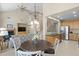 Open concept dining area adjacent to the kitchen and living room with vaulted ceilings at 10650 Ashfield St, Highlands Ranch, CO 80126