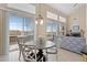 Bright dining area with large sliding glass doors, stylish chandelier, and backyard views at 10650 Ashfield St, Highlands Ranch, CO 80126