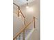 Carpeted staircase with white spindles and wood banister leads to the upper level at 10650 Ashfield St, Highlands Ranch, CO 80126