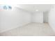 Bright and spacious basement with neutral paint, plush carpet and natural light from the egress window at 5554 Crystal Way, Denver, CO 80239