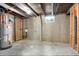 Unfinished basement with concrete floor, exposed ceiling, and a small window at 5554 Crystal Way, Denver, CO 80239