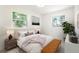 Cozy bedroom with dual windows, warm lighting, a comfortable bed, and tasteful decor at 5554 Crystal Way, Denver, CO 80239