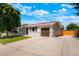 Charming single-story home with a well-manicured lawn, a driveway, and an attached single car garage at 5554 Crystal Way, Denver, CO 80239