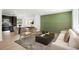 Open concept living room, dining, and kitchen area with modern decor and an accent wall at 5554 Crystal Way, Denver, CO 80239