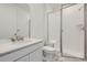 Clean bathroom featuring a vanity with a quartz countertop, a toilet, and a tiled shower with a glass door at 15153 W Dequesne Ave, Morrison, CO 80465