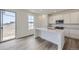 A modern kitchen featuring white cabinets, stainless steel appliances, and a central island with a sink at 15153 W Dequesne Ave, Morrison, CO 80465