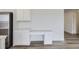 Bright kitchen showcasing white cabinets, countertops, and a built-in desk area, with modern design and a clean aesthetic at 15153 W Dequesne Ave, Morrison, CO 80465