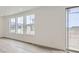 Bright living room with hardwood floors, white walls, and multiple windows offering plenty of natural light at 15153 W Dequesne Ave, Morrison, CO 80465