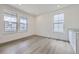 Bright and airy living room with light hardwood floors, white walls, and large windows for natural light at 15153 W Dequesne Ave, Morrison, CO 80465