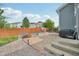 Backyard with stone patio, fire pit, and outdoor seating, perfect for entertaining in a charming home at 19707 E Caspian Cir, Aurora, CO 80013