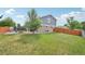 Expansive backyard with lawn area, stone patio, fire pit, and charming garden, perfect for outdoor activities at 19707 E Caspian Cir, Aurora, CO 80013