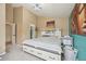 Cozy bedroom showcases a white bed with drawers, complemented by a modern light fixture and colorful artwork at 19707 E Caspian Cir, Aurora, CO 80013