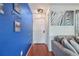 Inviting hallway with a vibrant blue accent wall and stylish zebra wall art at 19707 E Caspian Cir, Aurora, CO 80013