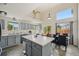 Spacious kitchen with an island, grey cabinetry, and lots of natural light at 19707 E Caspian Cir, Aurora, CO 80013