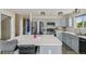 Modern kitchen features stainless steel appliances, gray cabinets, island, and a tiled backsplash at 19707 E Caspian Cir, Aurora, CO 80013