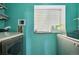 Functional laundry room with modern machines, a window, and storage shelves at 19707 E Caspian Cir, Aurora, CO 80013