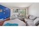 Cozy living room featuring a large sectional sofa and lots of natural light at 19707 E Caspian Cir, Aurora, CO 80013