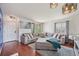 Bright living room featuring a large sectional sofa and wood flooring at 19707 E Caspian Cir, Aurora, CO 80013