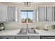 Bright kitchen sink with a large window showing the neighborhood outside at 19707 E Caspian Cir, Aurora, CO 80013