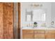 Stylish bathroom with double vanity, modern fixtures, and walk-in shower featuring rust-colored tiles at 6211 W Fremont Pl, Littleton, CO 80128