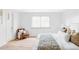 Serene bedroom with a cozy armchair, large window, and plush bed with decorative pillows at 6211 W Fremont Pl, Littleton, CO 80128