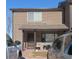 Inviting townhome featuring a covered front porch, outdoor seating, and neutral siding with dark trim details at 473 N Banner St # D, Elizabeth, CO 80107