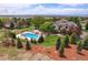 Beautiful aerial view of home featuring a pool, landscaping, and mountain views at 7818 S Zeno St, Centennial, CO 80016