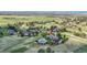 Picturesque aerial view showcasing a beautiful home with a pool, surrounded by lush greenery and a scenic landscape at 7818 S Zeno St, Centennial, CO 80016