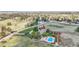 Expansive aerial view of a home with a pool, well-manicured lawn, and mature trees in a serene, countryside setting at 7818 S Zeno St, Centennial, CO 80016