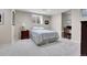 Cozy bedroom features plush carpeting, built-in shelving and a light color palette at 7818 S Zeno St, Centennial, CO 80016